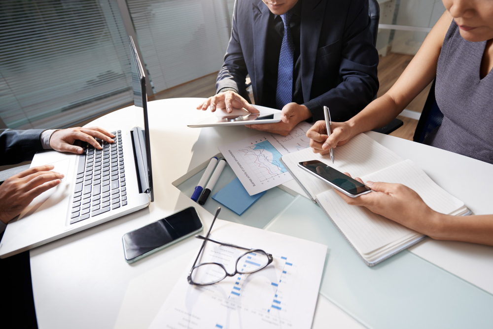 business-people-sitting-at-office-desk-working-on-project